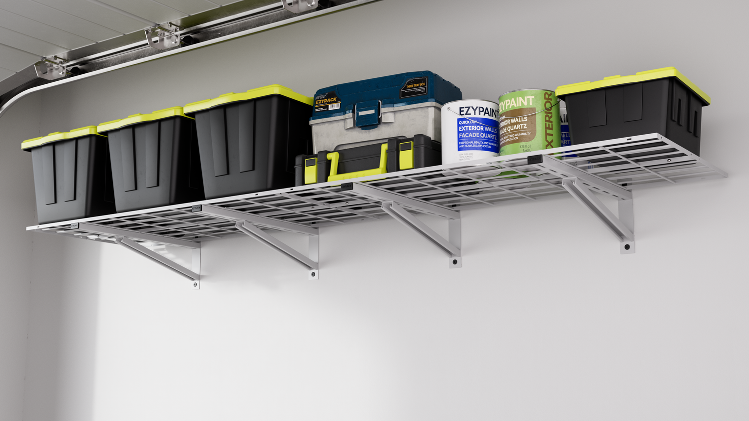 A wall-mounted white metal wire shelving unit in a garage, supporting heavy black storage bins with yellow lids, paint cans, and a blue tool chest.