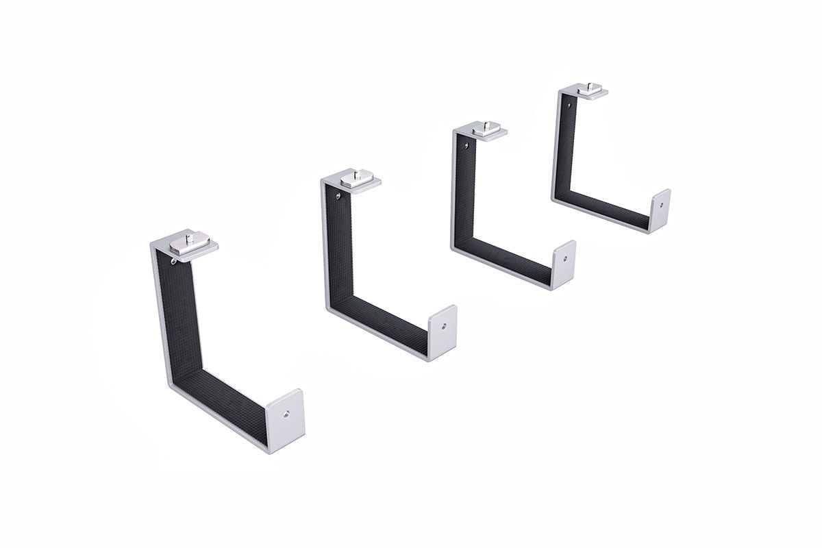 Four black metal brackets on a white background