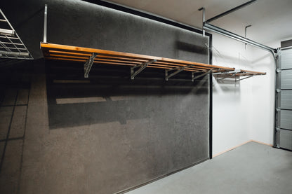 Wooden folding table against a gray wall in a garage setting
