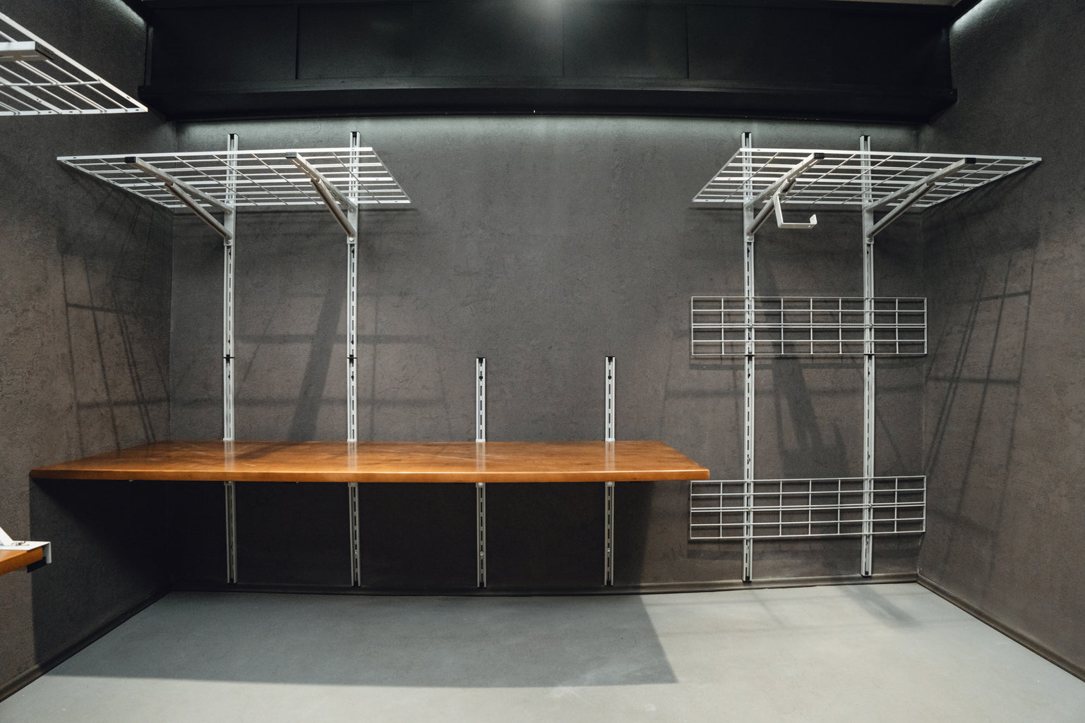 Wooden table with metal frame against a gray wall