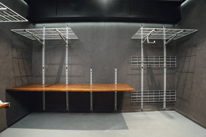 Wooden table with metal frame against a gray wall