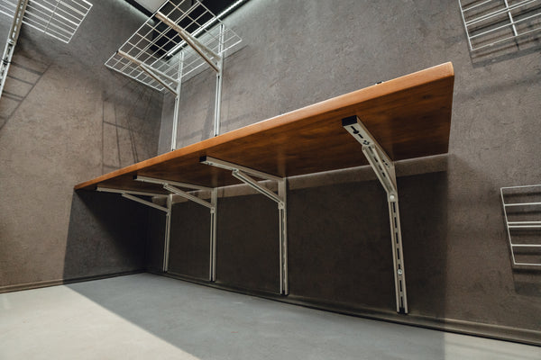Wooden table with metal legs against a gray wall
