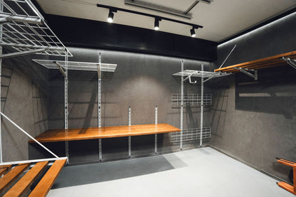 Modern storage room with metal shelving units and wooden platforms.