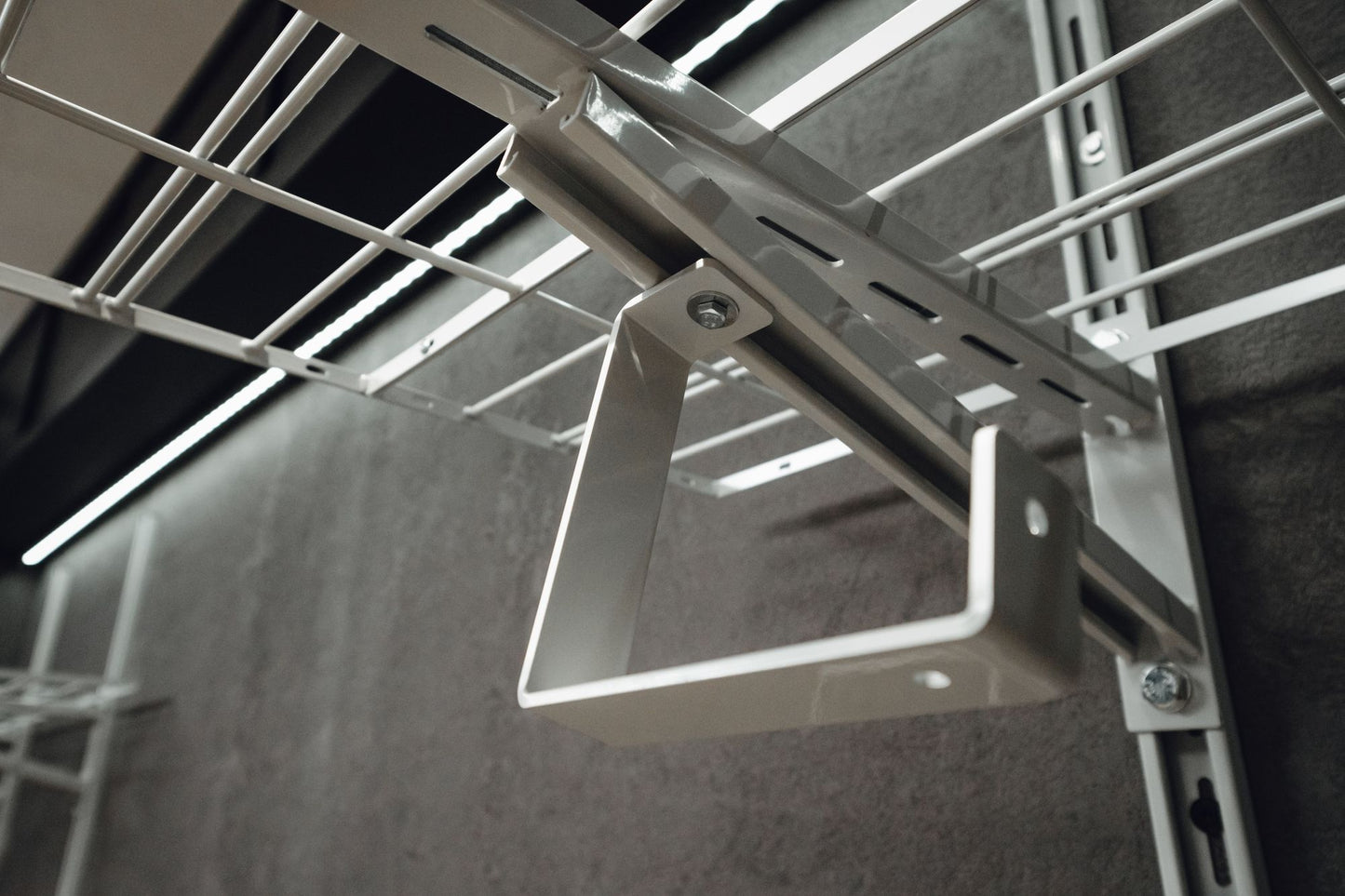 Metal ceiling grid with light fixture on a dark ceiling