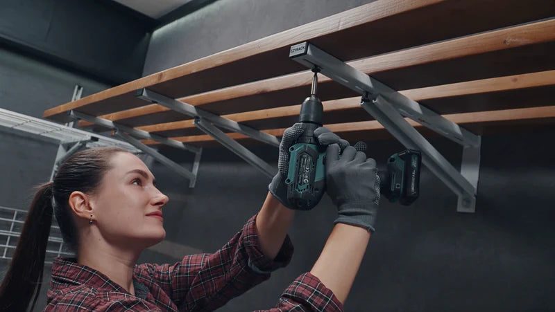 Image demonstrating the third step of the Tote Master Pro installation, showing a gloved hand inserting a grey wall plug into a hole along a marked line on a ceiling.